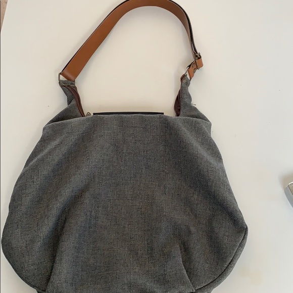 Leather strap and front clasp. Zippers shut. - Picture 4 of 5